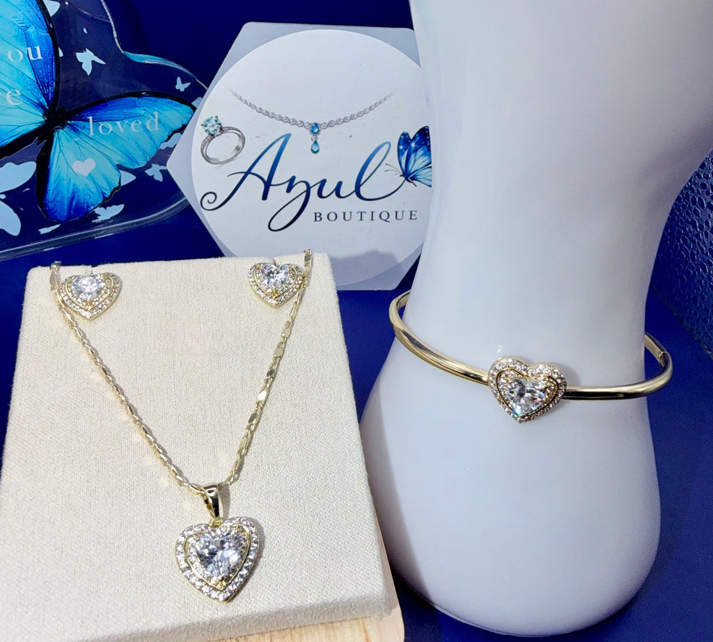 Timeless expression of love and elegance in this stunning 3-piece set. Features a delicate gold-tone necklace, matching heart-shaper stud earrings, and elegant bangle bracelet, each beautiful accented with sparkling clear stones.